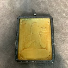A FINE SILVER AND BONE CARVED TIBETIAN NECKLACE PENDANT