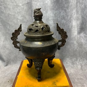 QIAN LONG MARKED GILT BRONZE TRIPOD INCENSE BURNER WITH CLOUD HANDLES AND LION FEET