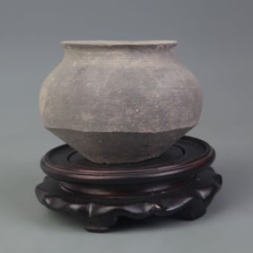 AN ANTIQUE POTTERY JAR