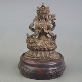 A SMALL BRONZE FOUR-ARMED GUANYIN