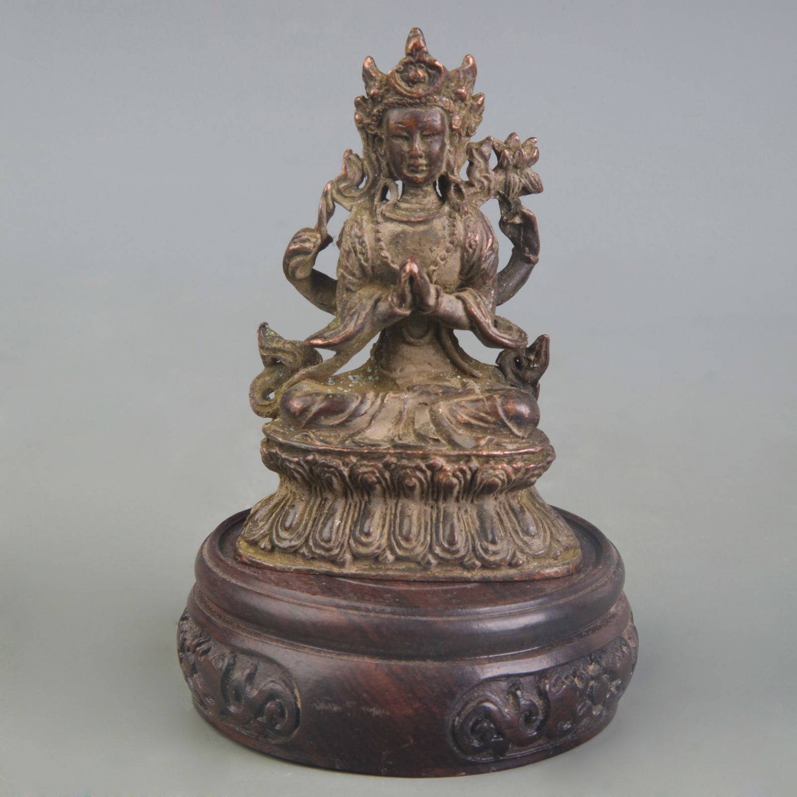 A SMALL BRONZE FOUR-ARMED GUANYIN (1 of 5)