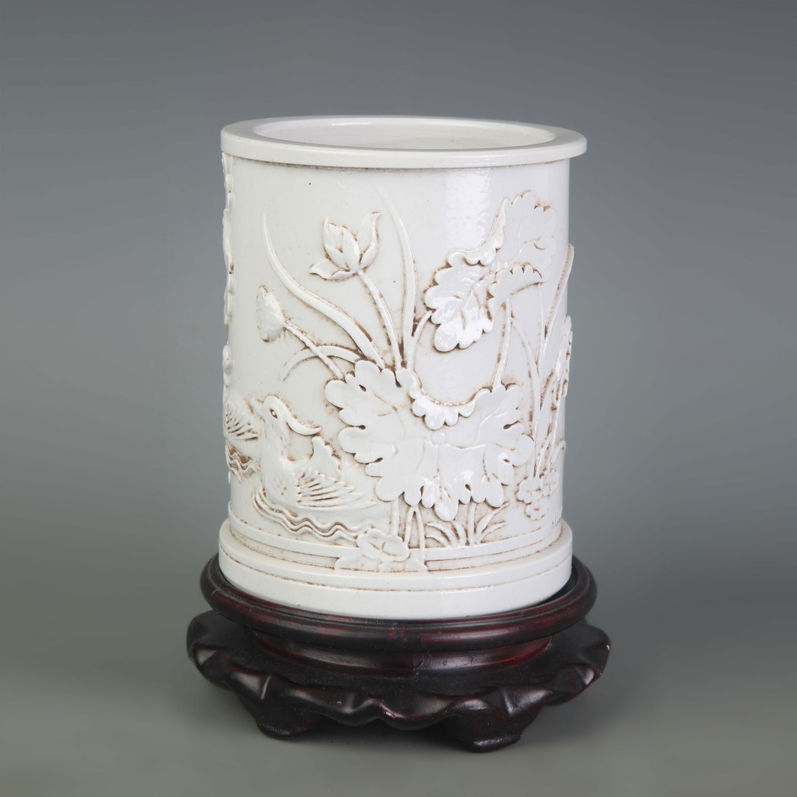 WHITE PORCELAIN CARVED FLORAL AND BIRD PORCELAIN BRUSH POT: Qing Dynasty; High: 5.4 inch; Diameter: 4.3 inch