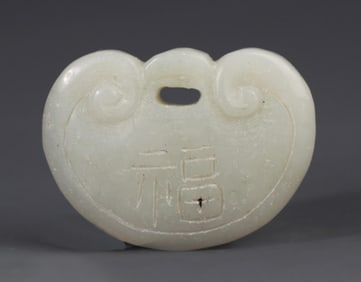 A FINE PALE CELADON JADE LOCK FIGURE PENDANT