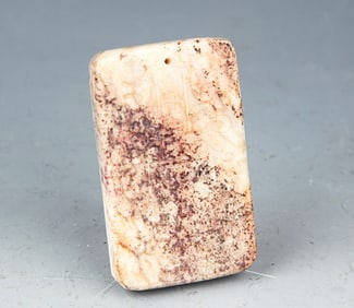 A FINELY CARVED WHITE JADE PENDANT