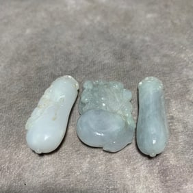 GROUP OF THREE JADEITE PENDANTS