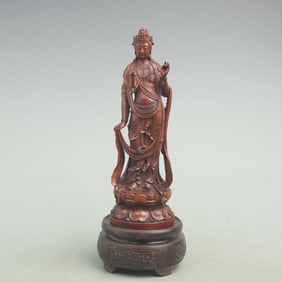 A FINE HUANGYANG WOOD GUANYIN FIGURINE