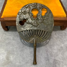 A SMALL BRONZE FAN FIGURE