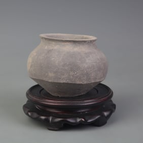 AN ANTIQUE POTTERY JAR