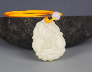 A FINELY CARVED HETIAN PALE CELADON JADE PENDANT PENDANT