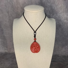 A FINE CINNABAR CARVED NECKLACE