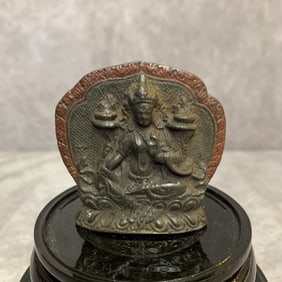 A SMALL BRONZE TIBETAN PENDANT