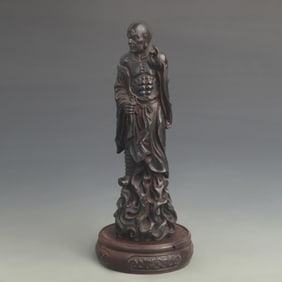 A FINE BLACK SANDALWOOD CARVED ARHAT STATUE