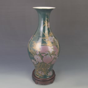 A DARK GREEN GLAZED PEACH PATTERN GUAN YIN VASE