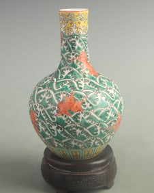 FAMILLE ROSE CELESTIAL VASE WITH FISH AND WAVE PATTERNS ON GREEN GROUND
