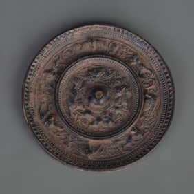 BRONZE MIRROR WITH SEA-CREATURE AND GRAPE DESIGN