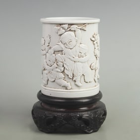 CARVED PORCELAIN BRUSH HOLDER WITH DEPICTION OF CHILDREN PLAYING