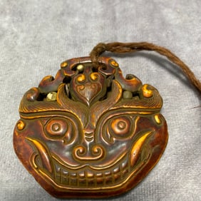 BONE MADE PENDANT WITH BEAST MASK DESIGN