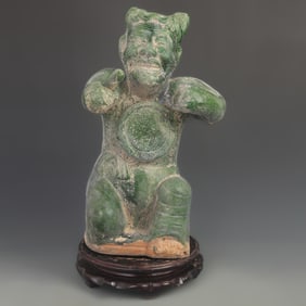 GREEN-GLAZED SINGING-AND-DRUMMING POTTERY FIGURINE