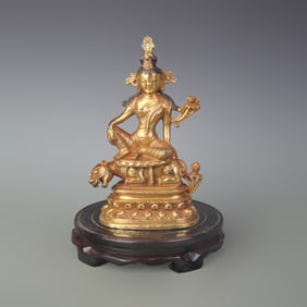 A FINE BRONZE GUANYIN RIDING BEAST STATUE