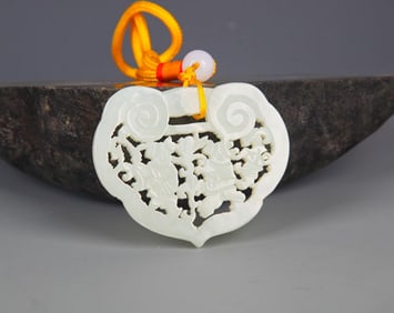 A FINELY CARVED HETIAN PALE CELADON JADE PENDANT PENDANT