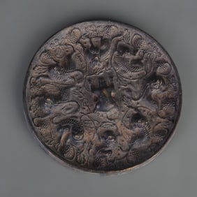 BRONZE MIRROR WITH MYTHICAL SEA-BEAST AND GRAPE DECORATION