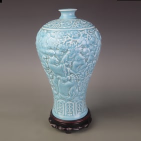 CELADON-GLAZED CARVED PORCELAIN PLUM-SHAPED VASE