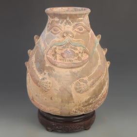A FINE COLOR PAINTED ANIMAL FACE POTTERY JAR