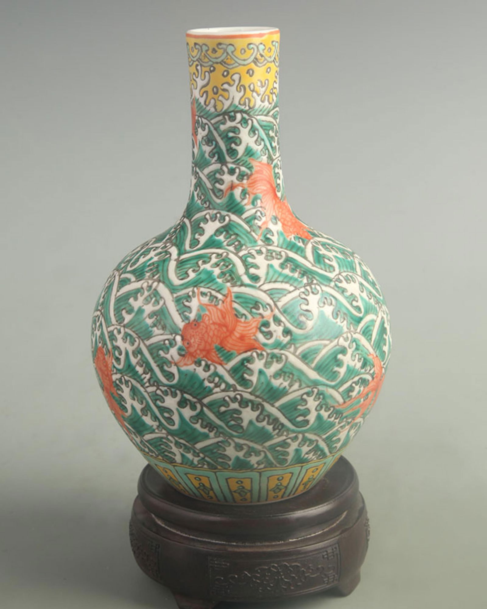 FAMILLE ROSE CELESTIAL VASE WITH FISH AND WAVE PATTERNS ON GREEN GROUND: Qing Dynasty Qian Long Period; High: 8.50 inch; Width: 5.20 inch;