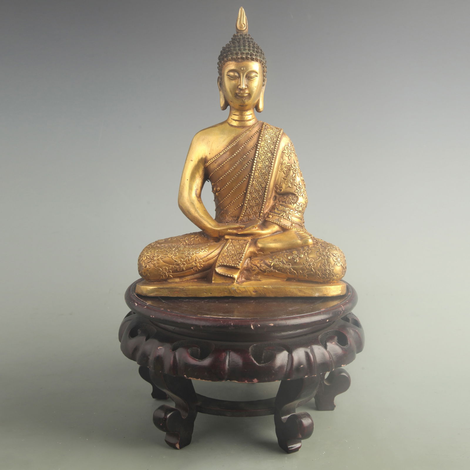A FINE GILT-BRONZE SHAKYAMUNI STATUE: 20th Century; High: 10.5 inch; Width: 7.70 inch