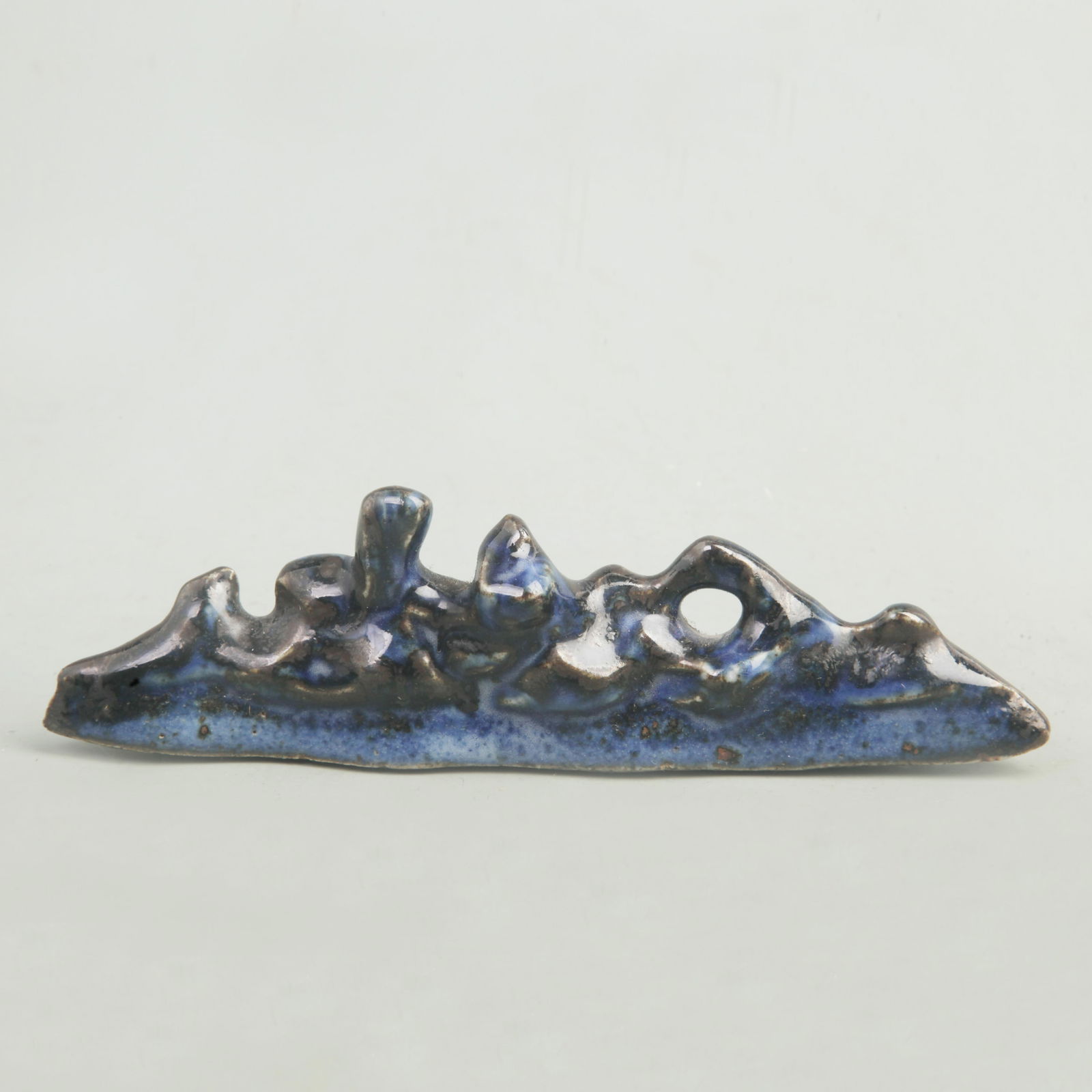 A FINE BLUE GLAZED MOUNTAIN-SHAPED PORCELAIN PEN STAND: Qing Dynasty, Long: 6.8 inch; High: 2.1 inch;