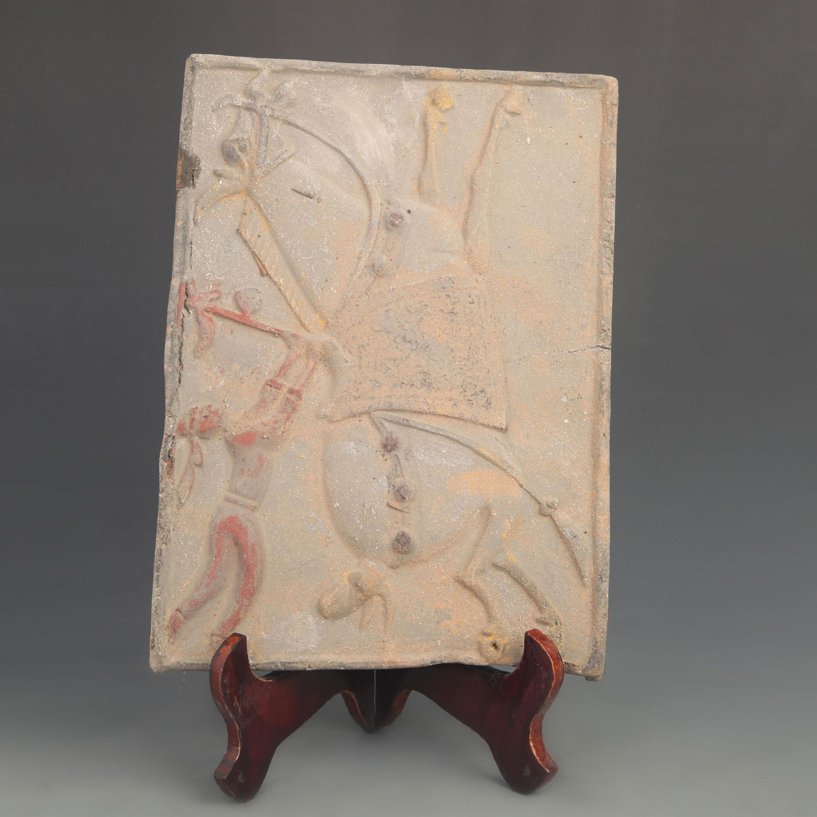 CERAMIC TILE CARVING OF A TANG DYNASTY FIGURE WITH A BOUND BALL (1 of 4)