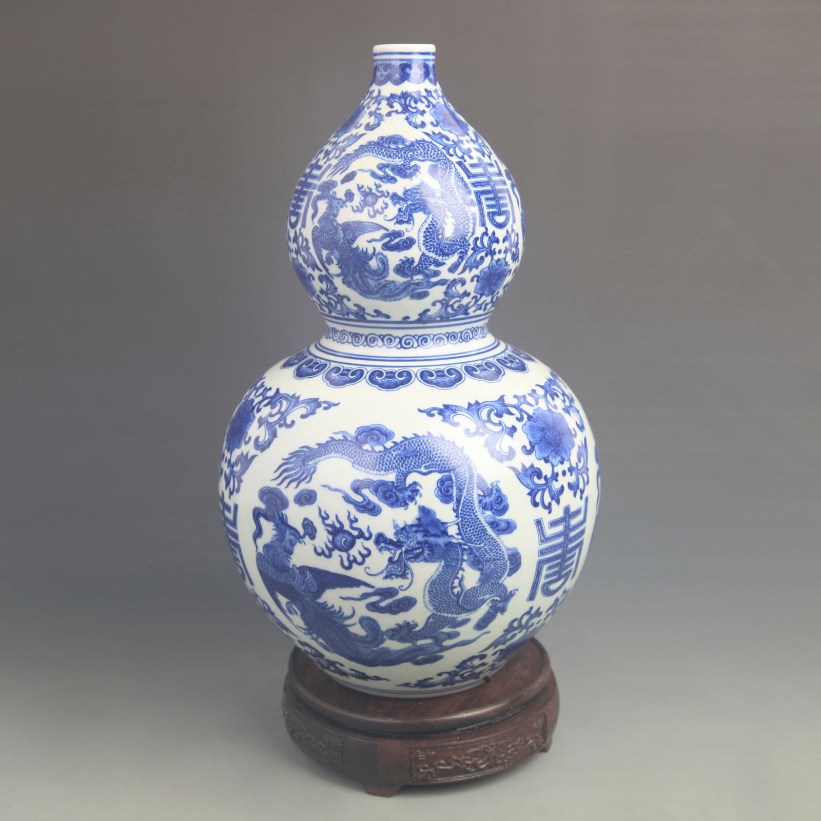 BLUE-AND-WHITE DRAGON-AND-PHOENIX GOURD VASE: Qing Dynasty Qian Long Period; High: 14.0 inch; Diameter: 8.00 inch