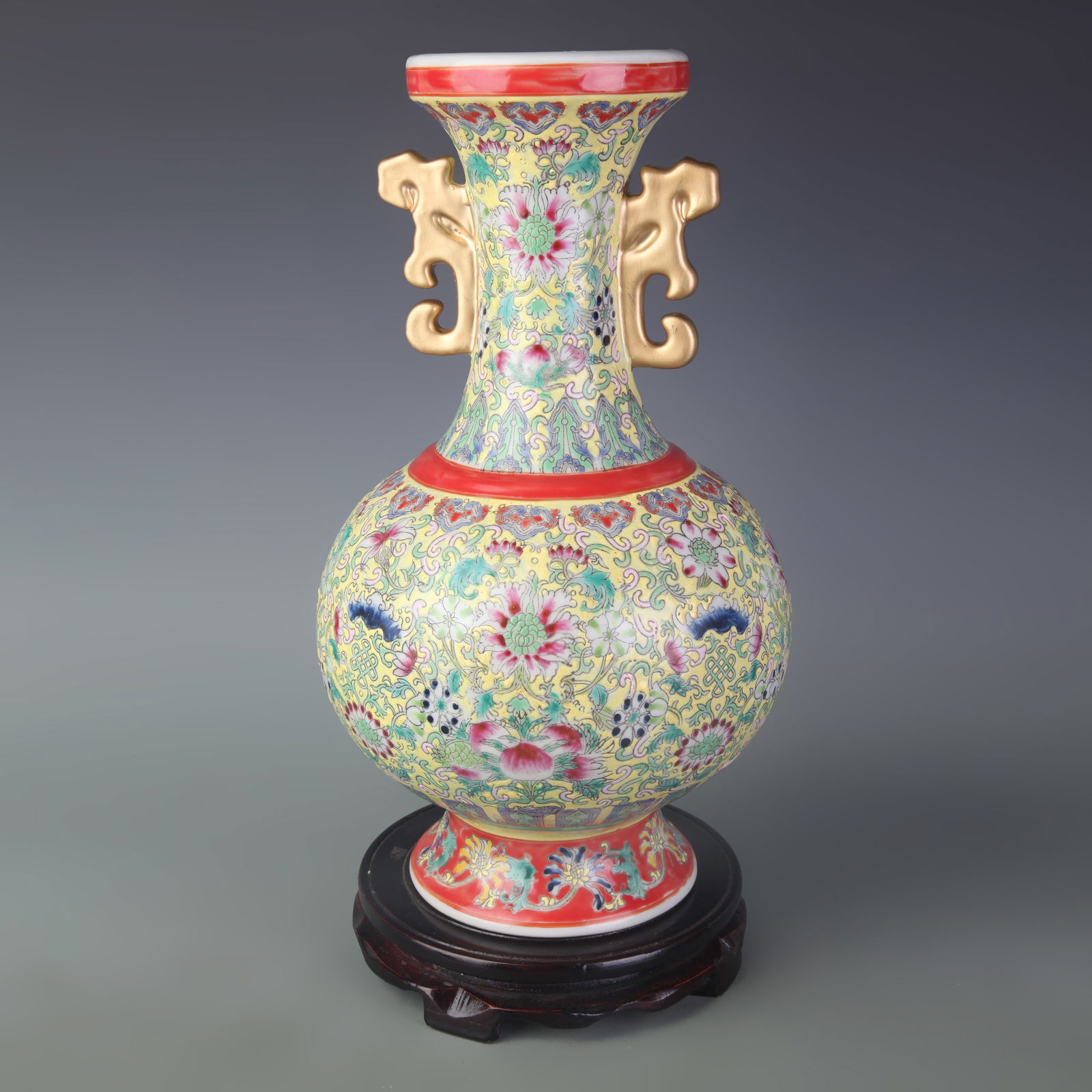 FAMILLE ROSE YELLOW-GROUND FLORAL PATTERNED TWIN-EAR PORCELAIN VASE: Qing Dynasty; Diameter: 4.4 inch; High: 13.9 inch;