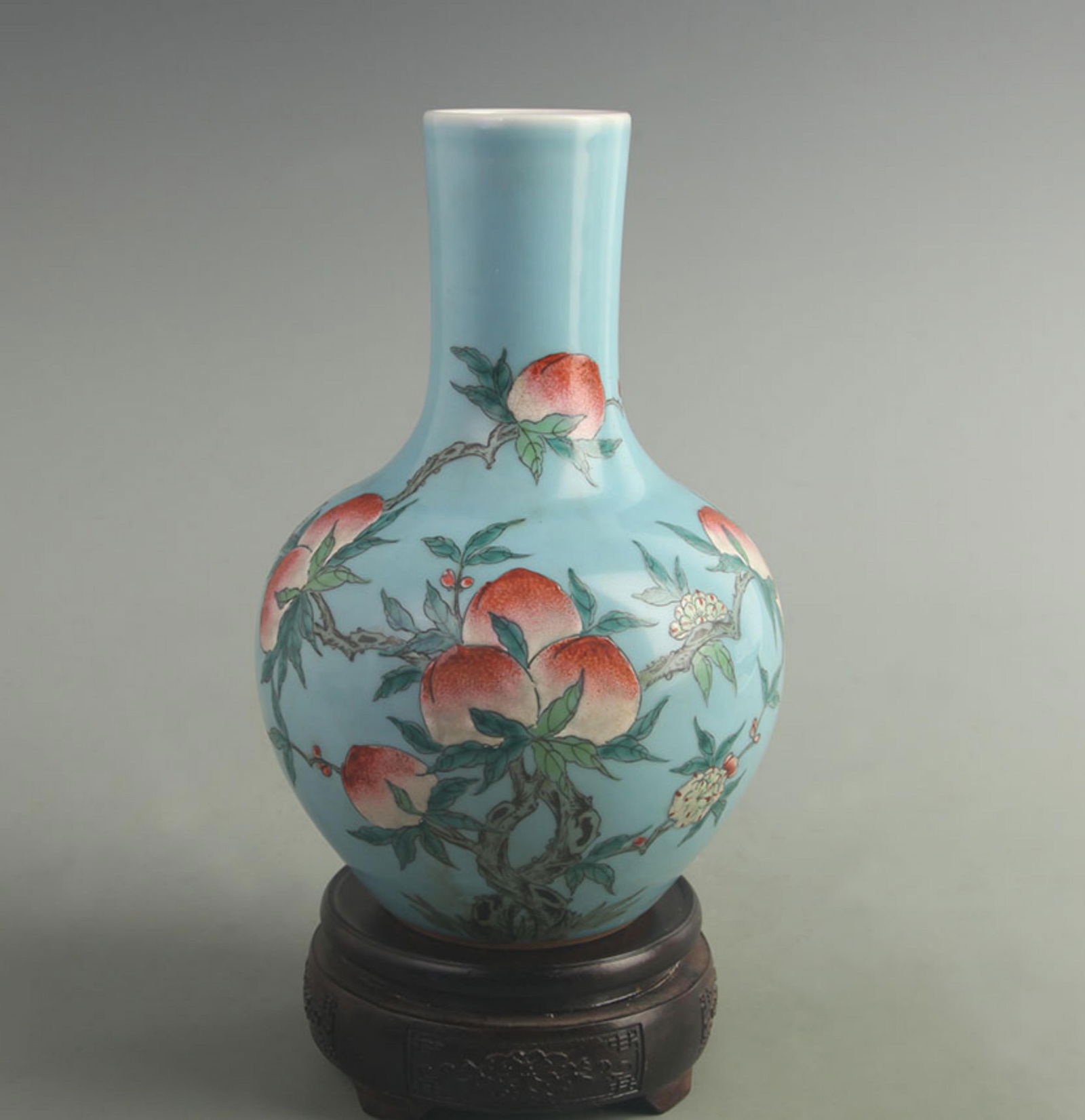 BLUE GROUND FAMILLE ROSE NINE PEACHES ROUND STYLE PORCELAIN VASE: Qing Dynasty; Qianlong Period; High: 9.00 inch; Width: 5.50 inch;