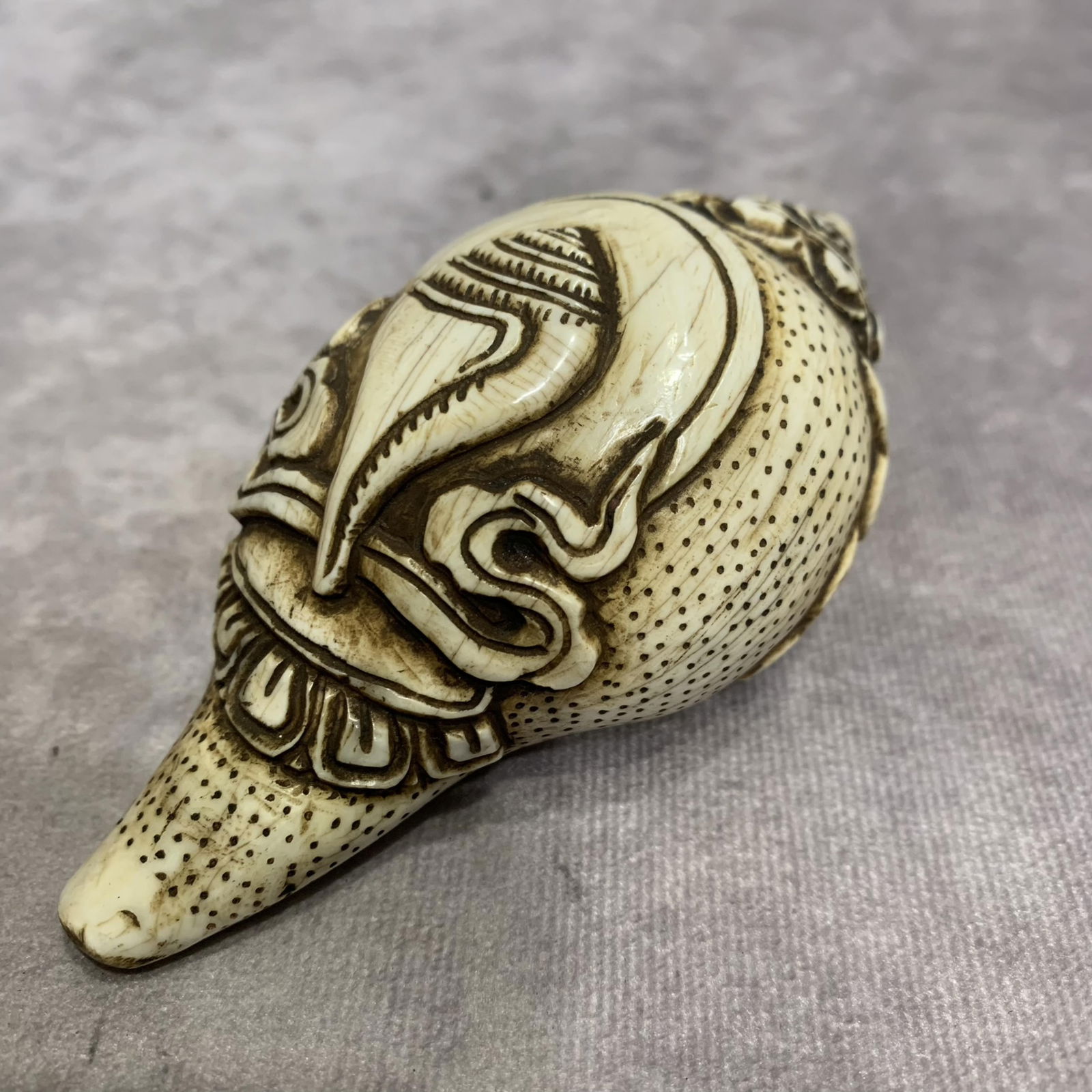 A FINELY CARVED TIBETAN CONCH: Modern; High: 2.0 inch; Width: 2.2 inch; Long: 4.0 inch;