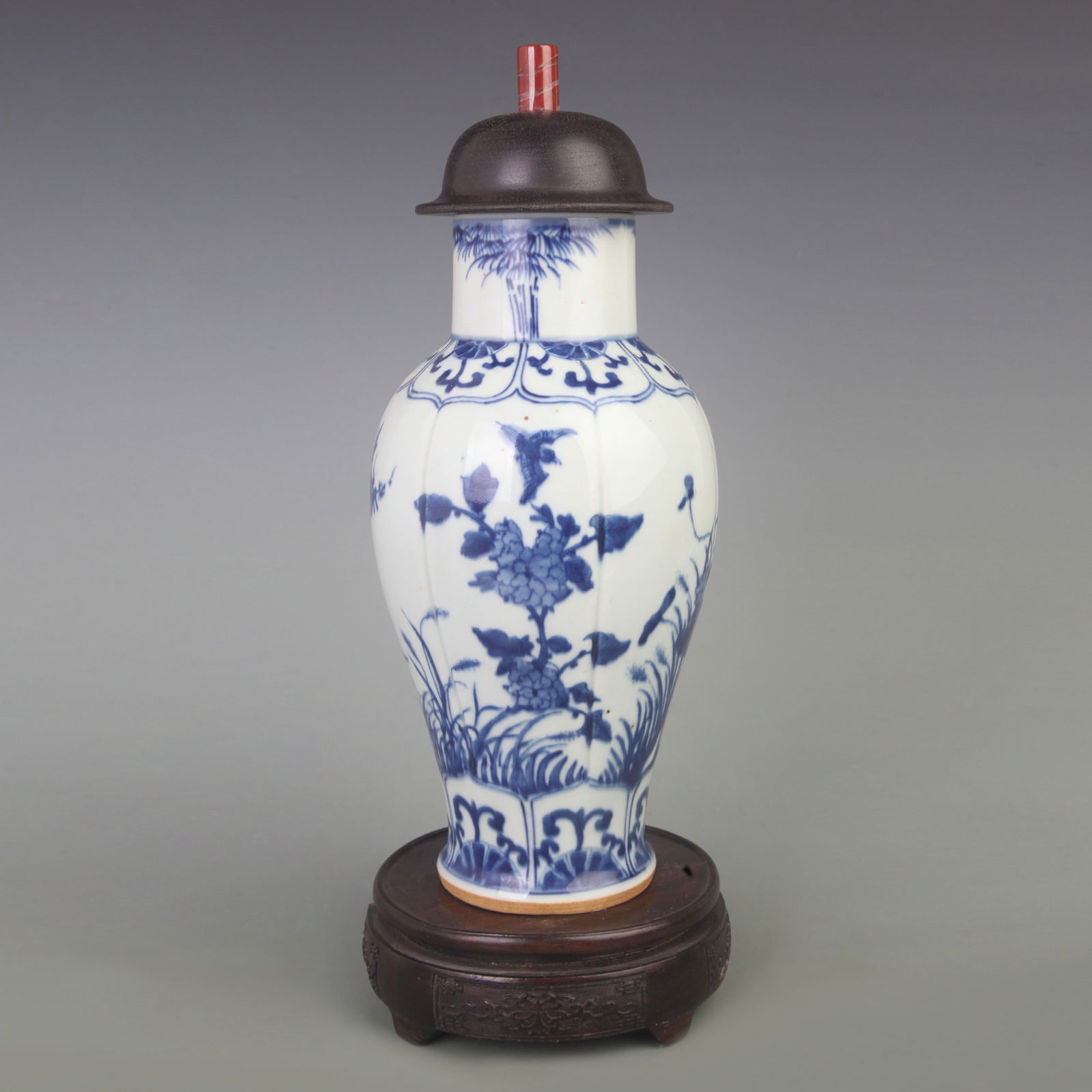 BLUE AND WHITE FLORAL-AND-BIRD GINGER JAR WITH HARDWOOD LID AND JADE FINIAL: Qing Dynasty; Diameter: 4.7 inch; High:12.5 inch;