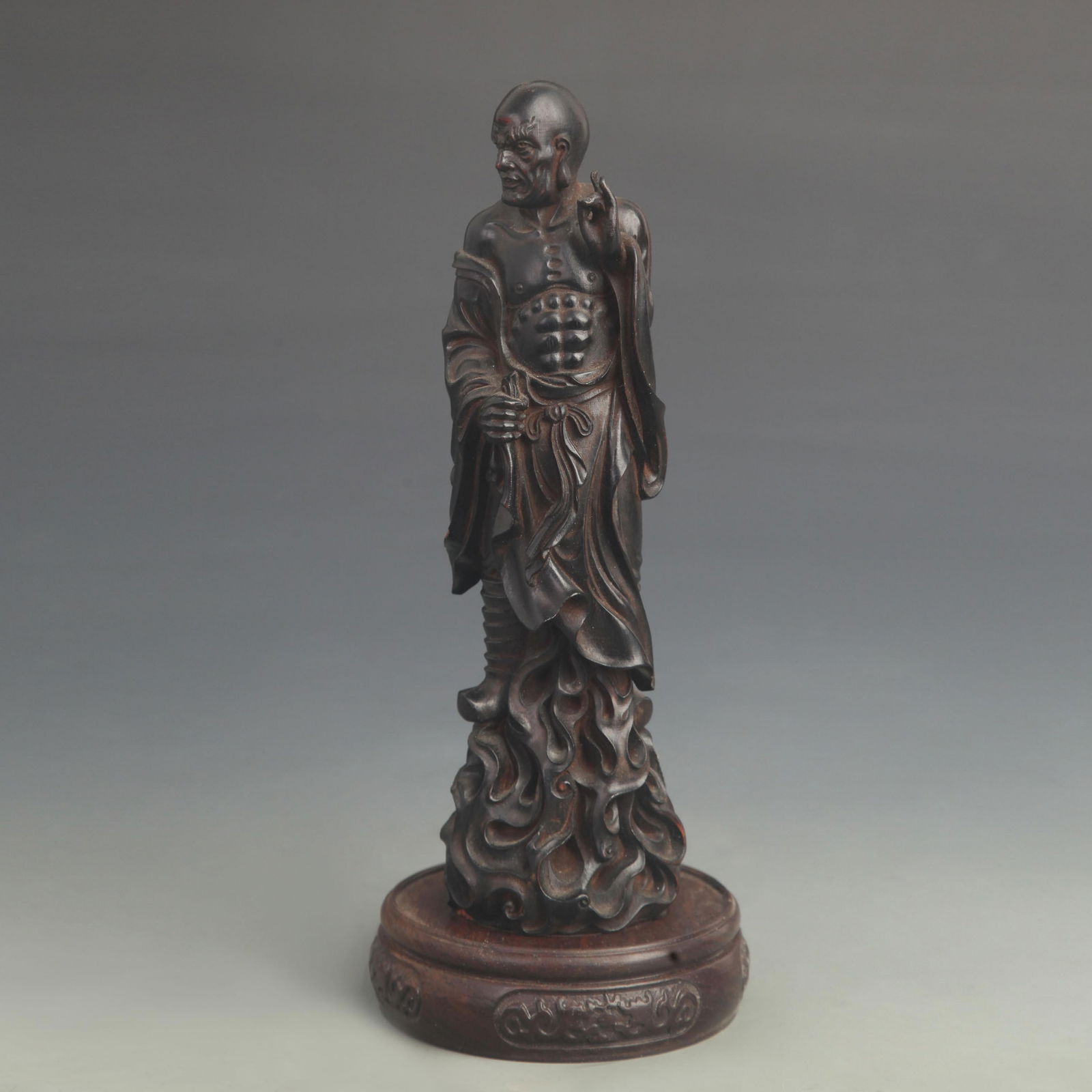 A FINE BLACK SANDALWOOD CARVED ARHAT STATUE (1 of 5)