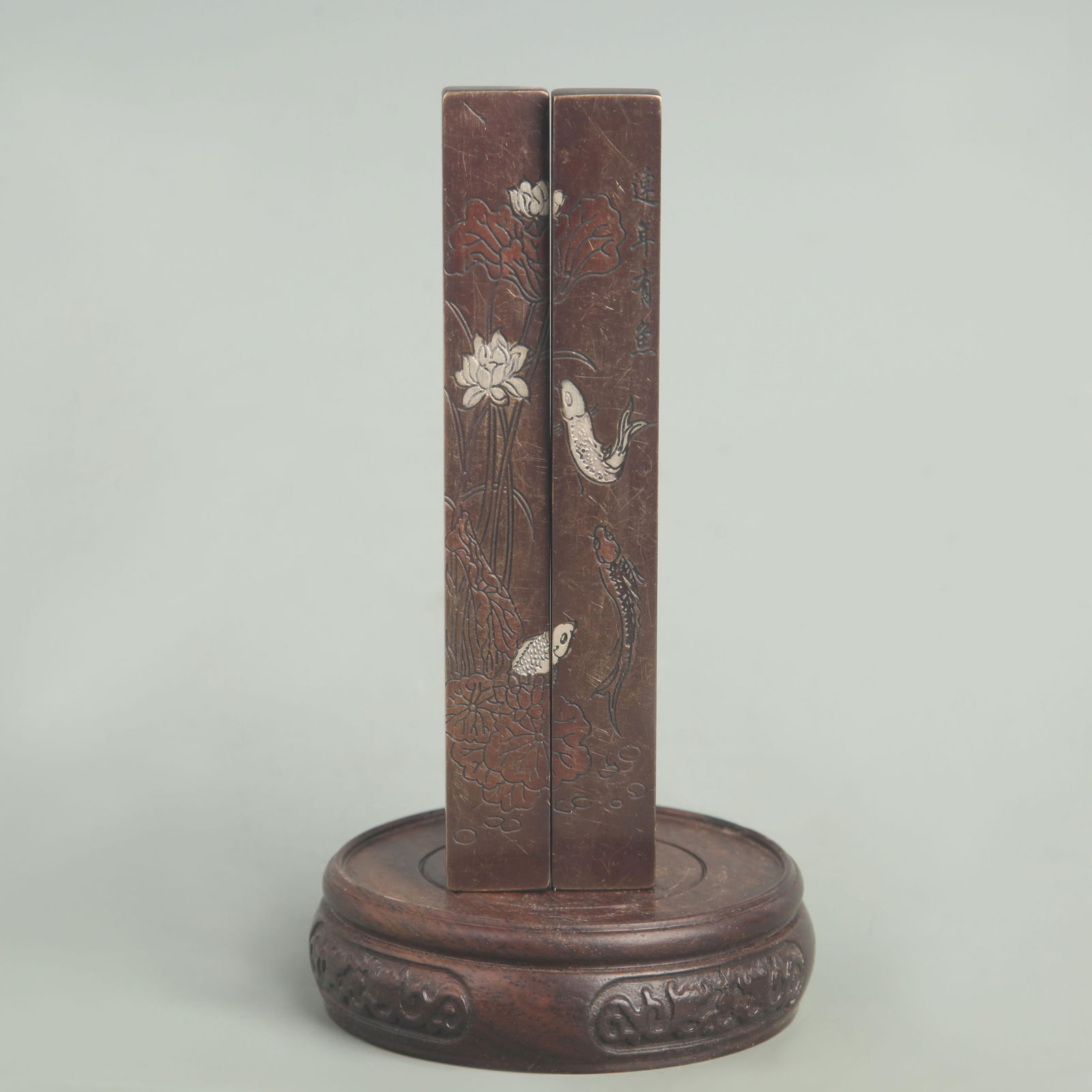 BRONZE PAPER WEIGHT INLAID WITH SILVER LOTUS AND FISH PATTERN: Republic Period; High: 6.00 inch; Width: 0.75 inch;