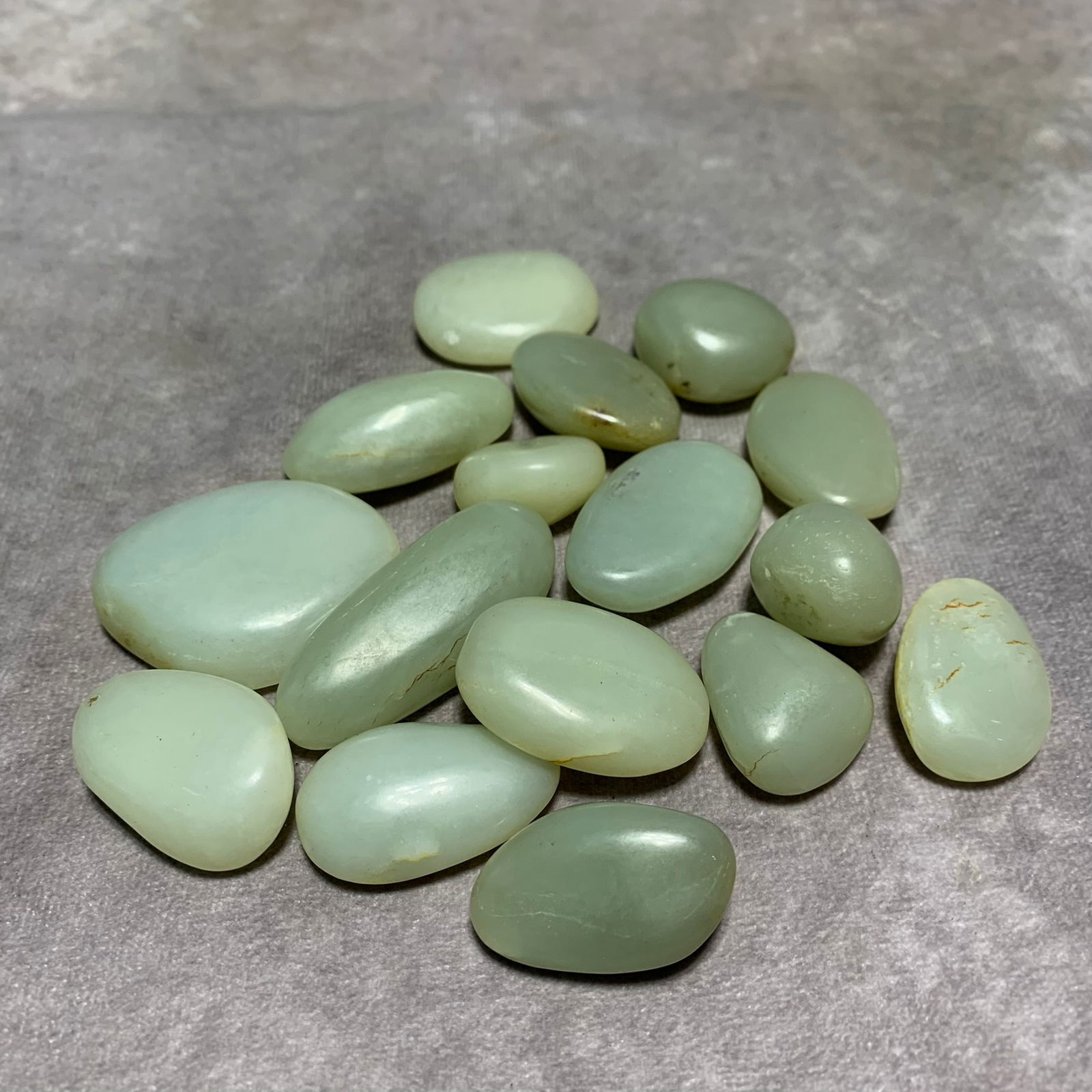 GROUP OF 16 HETIAN GREENISH-WHITE JADE BEADS: Modern; Long: 1.9-0.9 inch; Width: 1.4--0.8 inch;