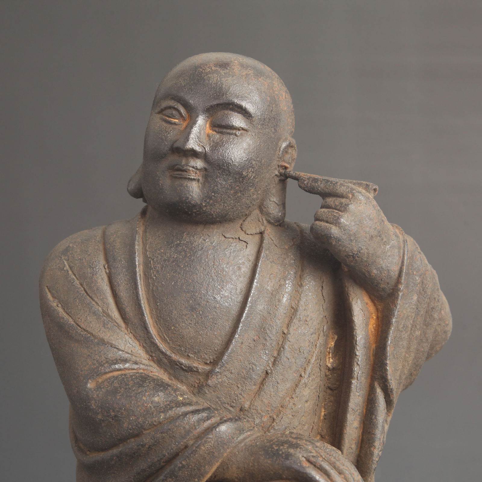 A FINE CAST IRON EAR-PICKING ARHAT - 2