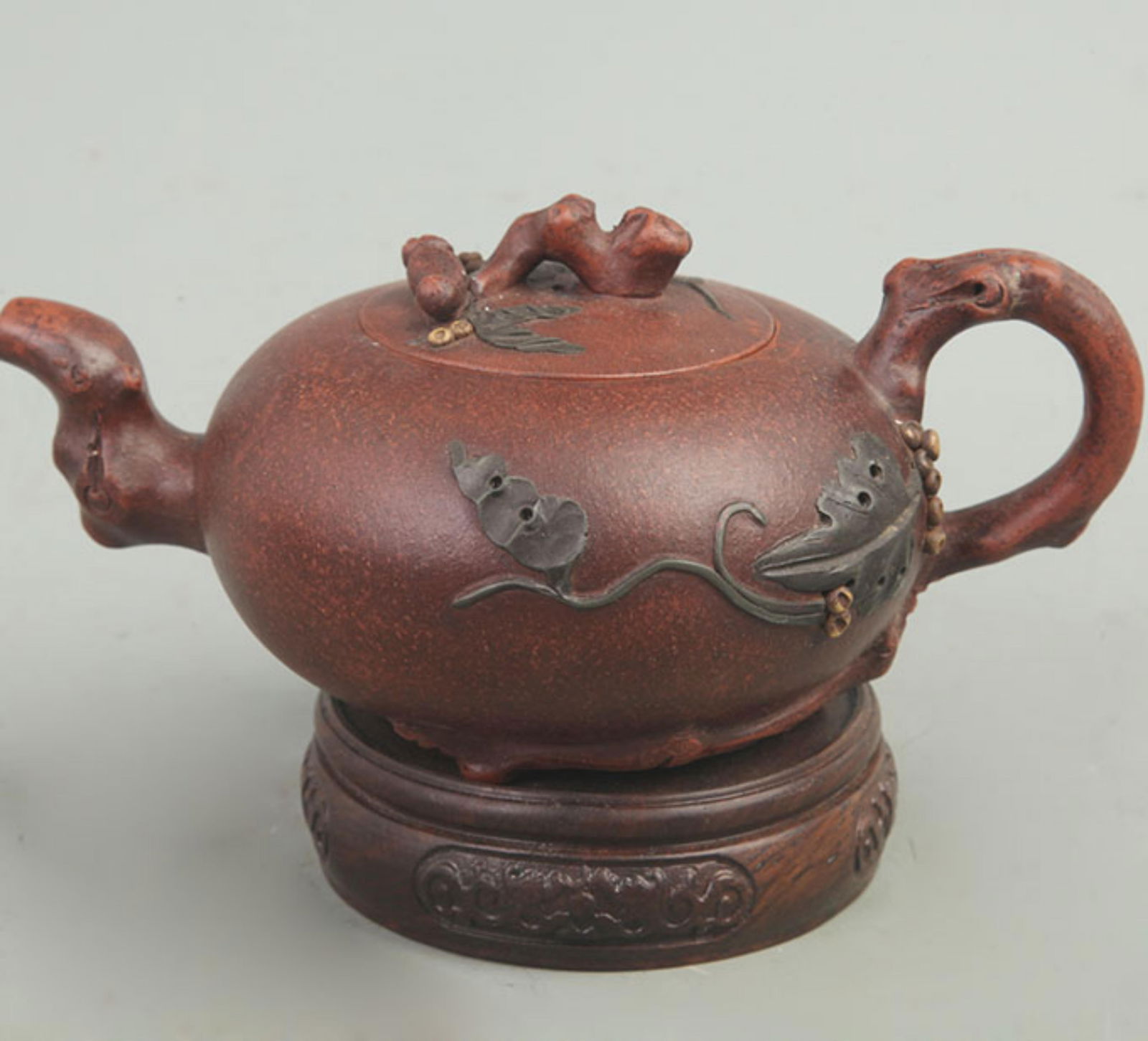 A FINELY CARVED ZI SHA TEAPOT: Modern; High: 3.8 inch; Long: 7 inch;