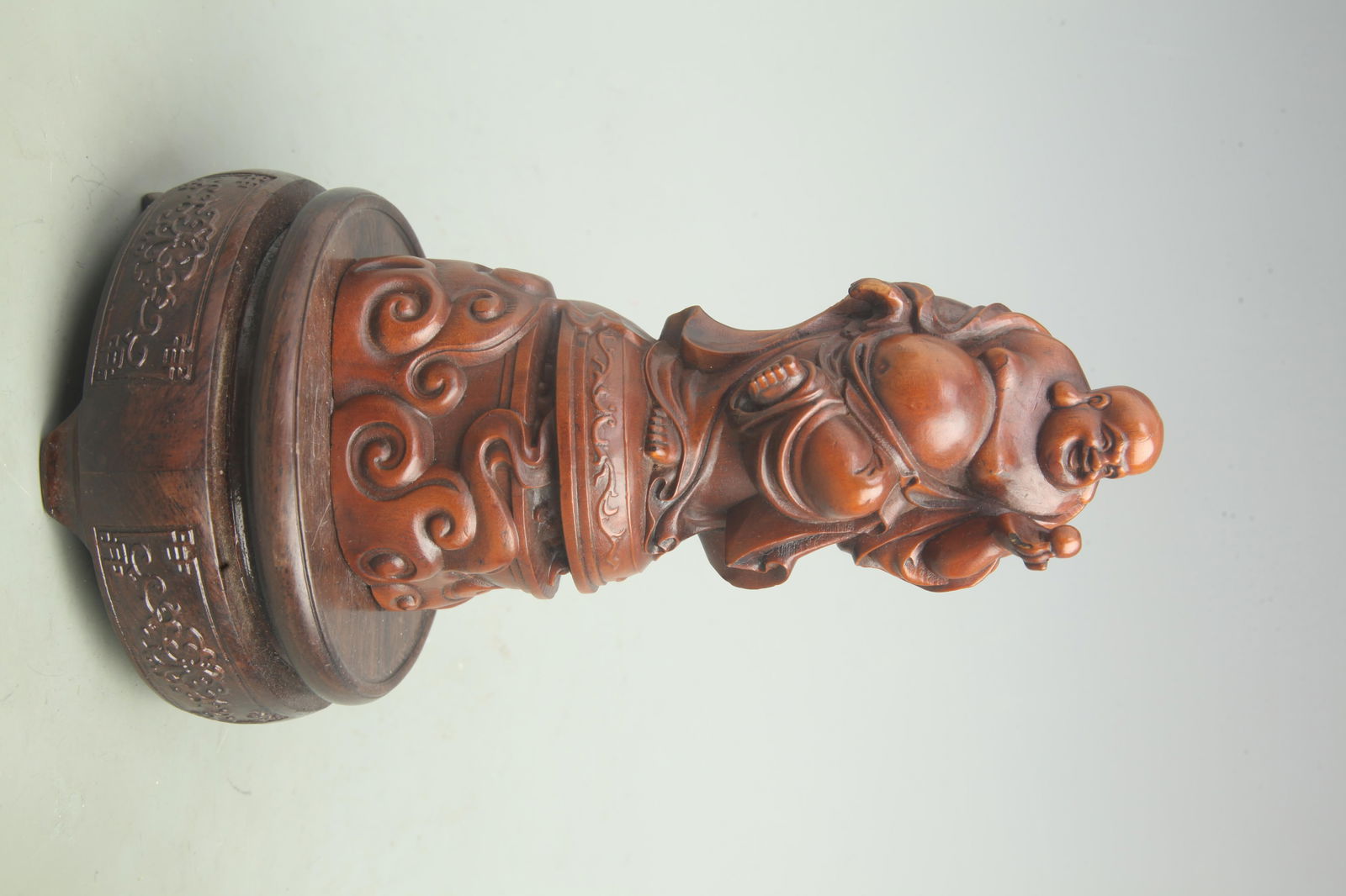 HUANGYANG WOOD FIGURINE OF MAITREYA BUDDHA WITH A LARGE BELLY: Qing Dynasty; High: 6.3 inch; Width: 2.9 inch;