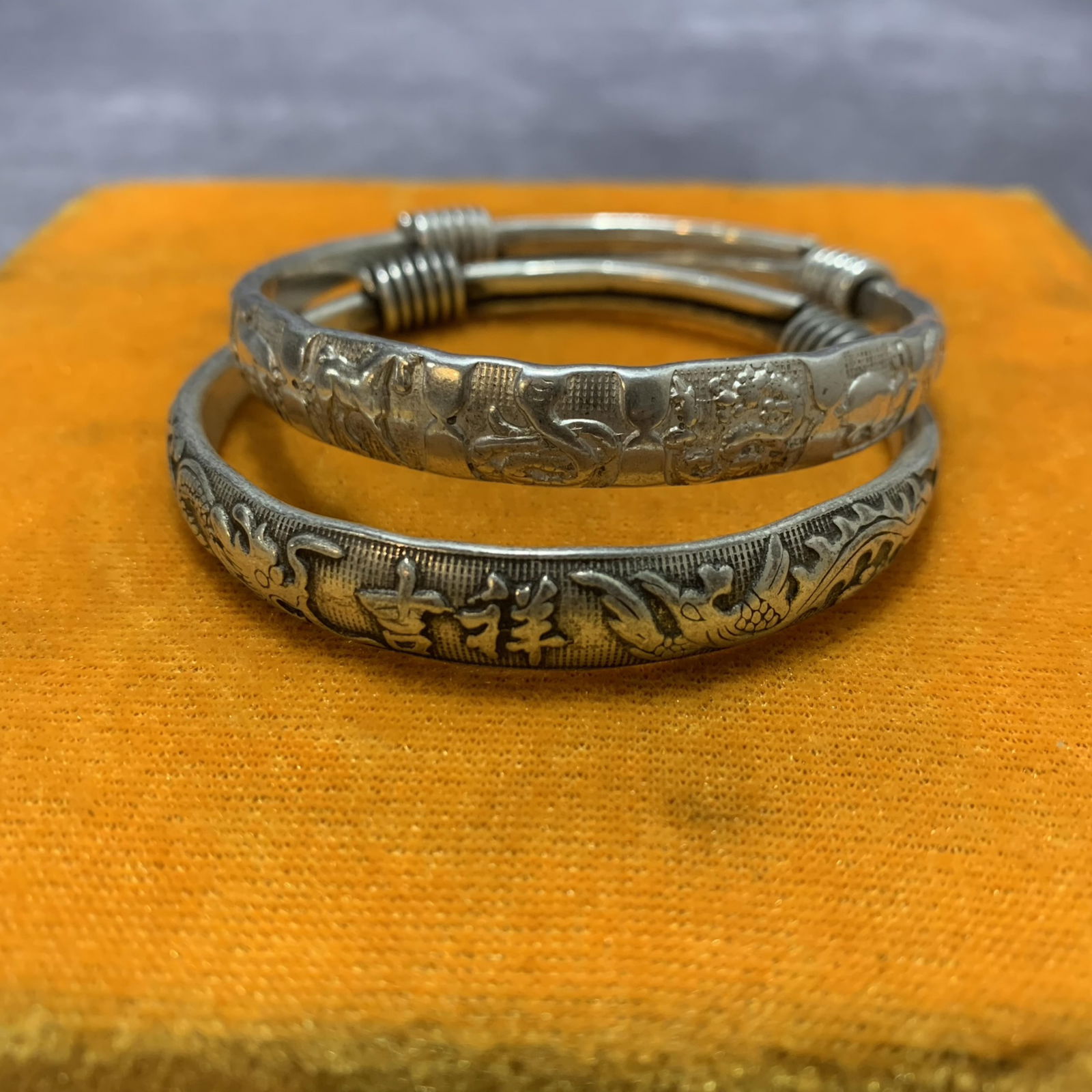 PAIR OF WHITE BRONZE CARVED BRACELETS: Modern; Diameter: 2.6 inch;