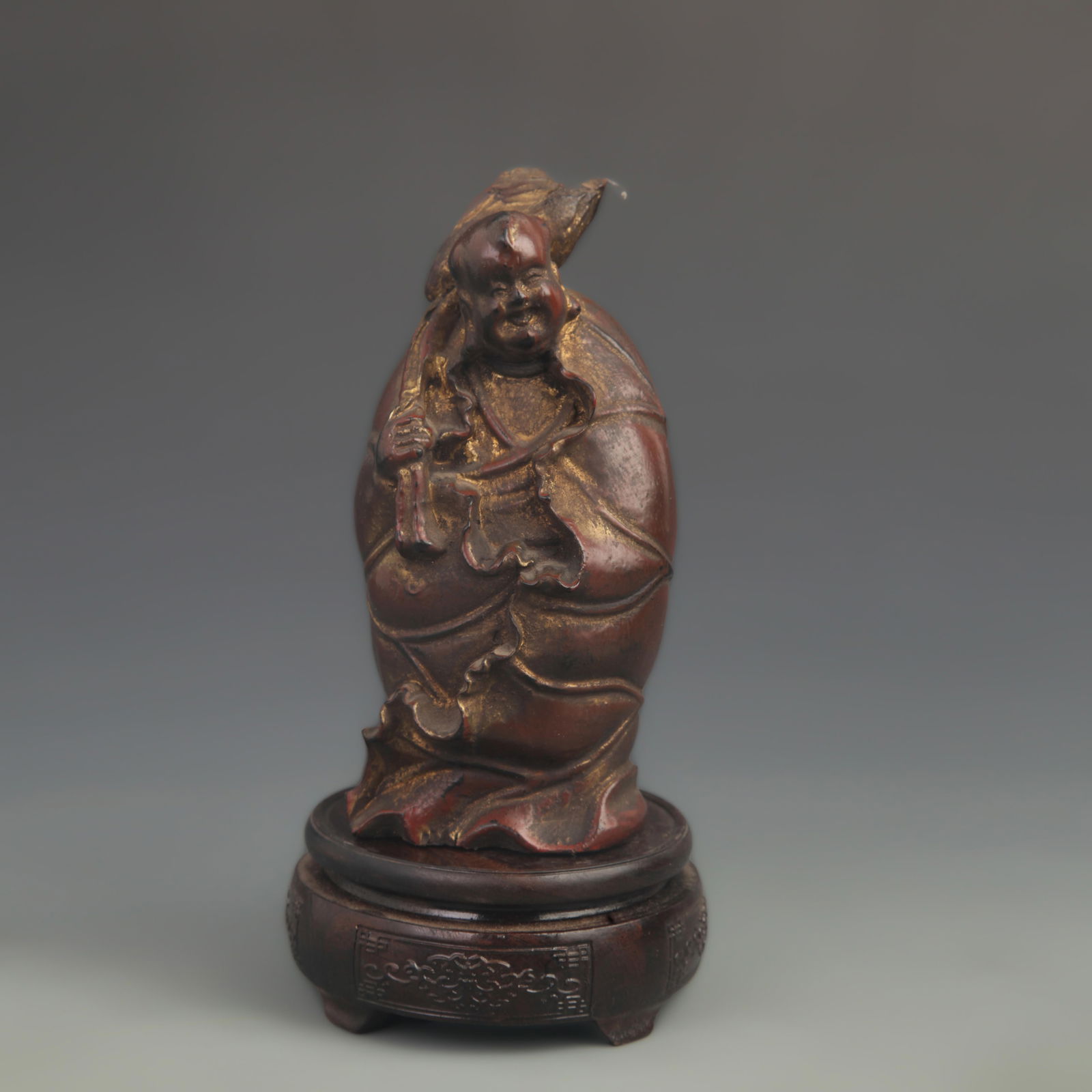 A FINE CARVED LACQUER AND LOTUS LEAF CHILD WOOD FIGURE: 20th Century; High: 7.25 inch; Width: 3.50 inch;