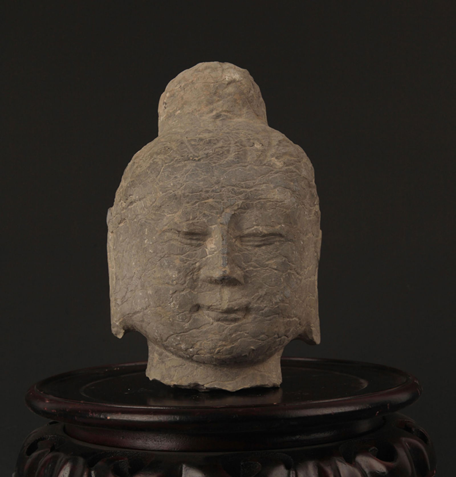 A FINELY CARVED STONE BUDDHA HEAD: North Wei Period; High: 7.25 inch; Width: 5.25 inch;