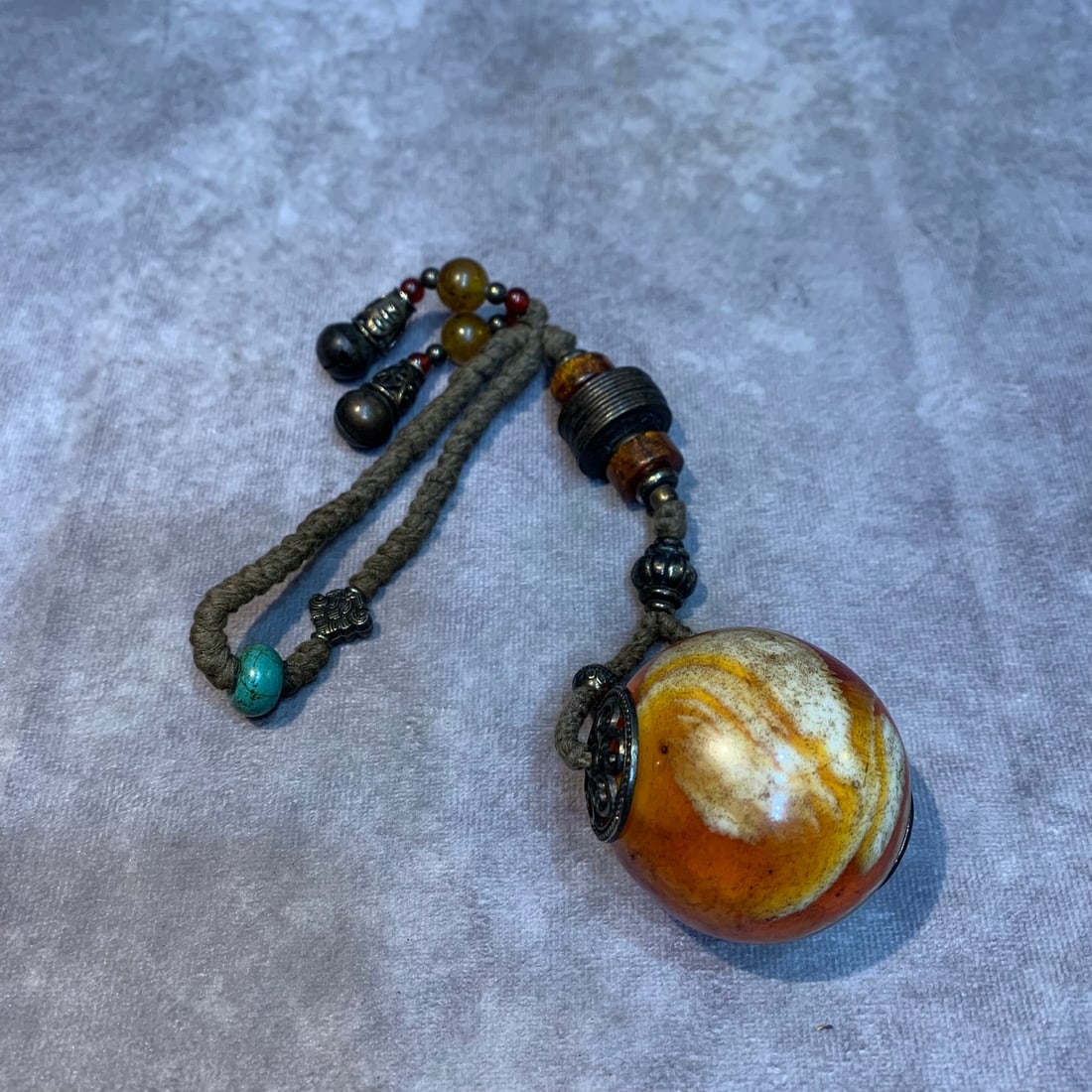 A FINE BEESWAX MADE PENDANT: Modern; High: 10.0 inch; Diameter: 2.0 inch