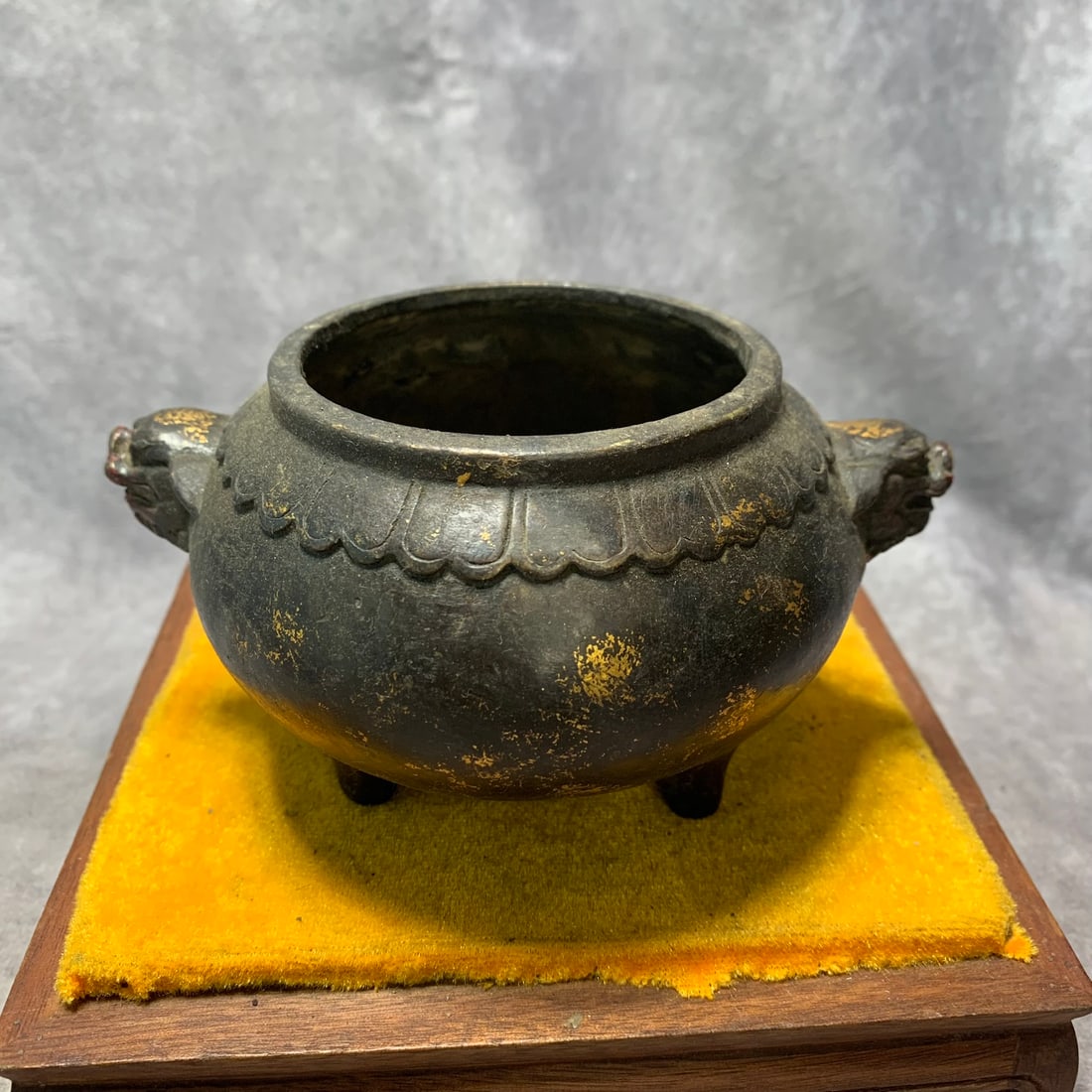 QIAN LONG MARKED GILT BRONZE TRIPOD CENSER WITH LION EARS AND AUSPICIOUS HANDLES: Qing Dynasty; High: 2.9 inch; Diameter: 5.4 inch