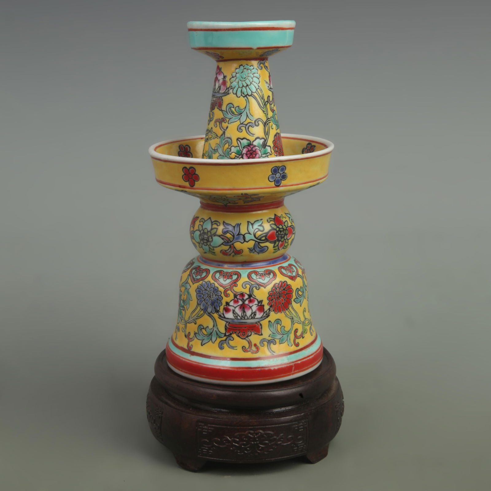 FAMILLE ROSE YELLOW GROUND FLOWER PATTERN CANDLESTICK: Qing Dynasty Qianlong Period, High: 8 inch; Width: 4.5 inch;