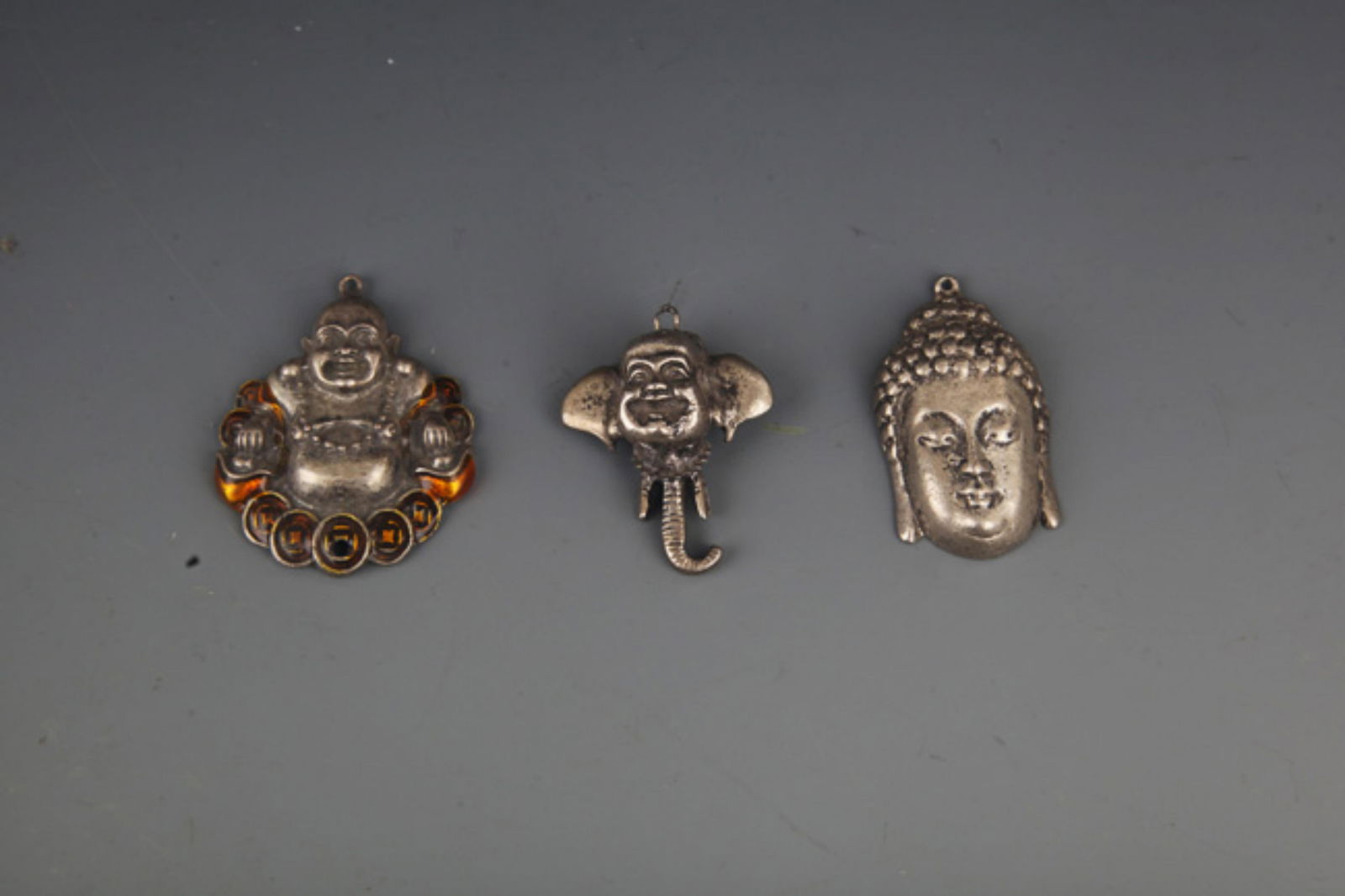 GROUP OF THREE SMALL BUDDHA PENDANT: 20th Century; High: 1.75 inch; High: 1.0 inch;
