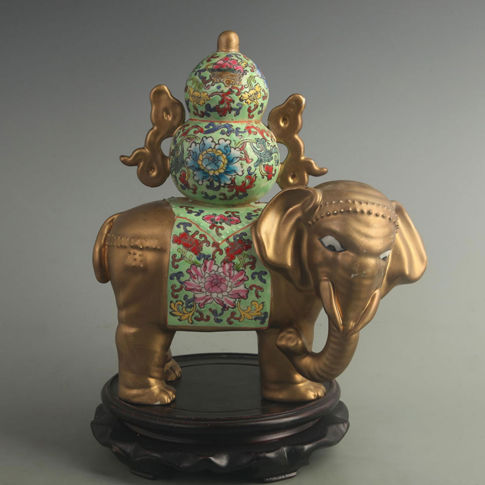FAMILLE ROSE GLAZED GOLD-PAINTED PEACE AND PROSPERITY ELEPHANT: Qing Dynasty Yong Zheng Period;High: 10.8 inch; Width: 10.0 inch;